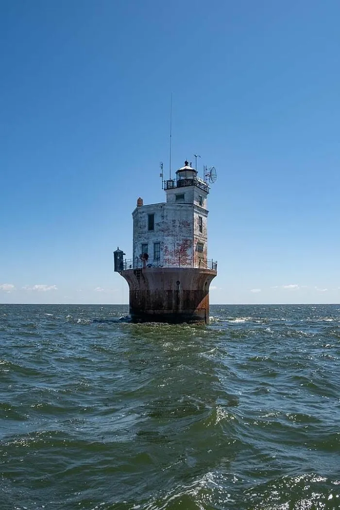 Isolated lighthouse strange building standing on sea waters
