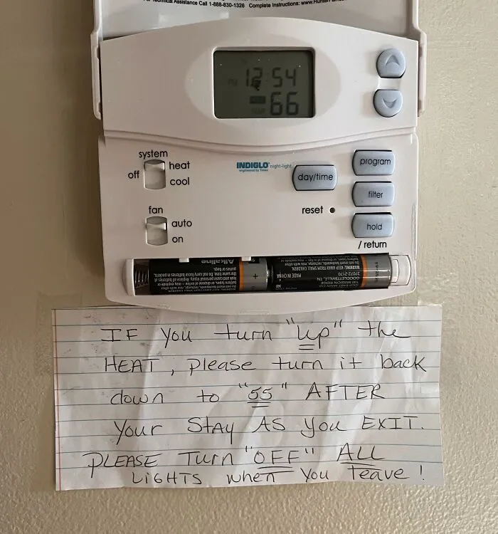 A handwritten note under a thermostat with misused quotation marks around words like up and off.