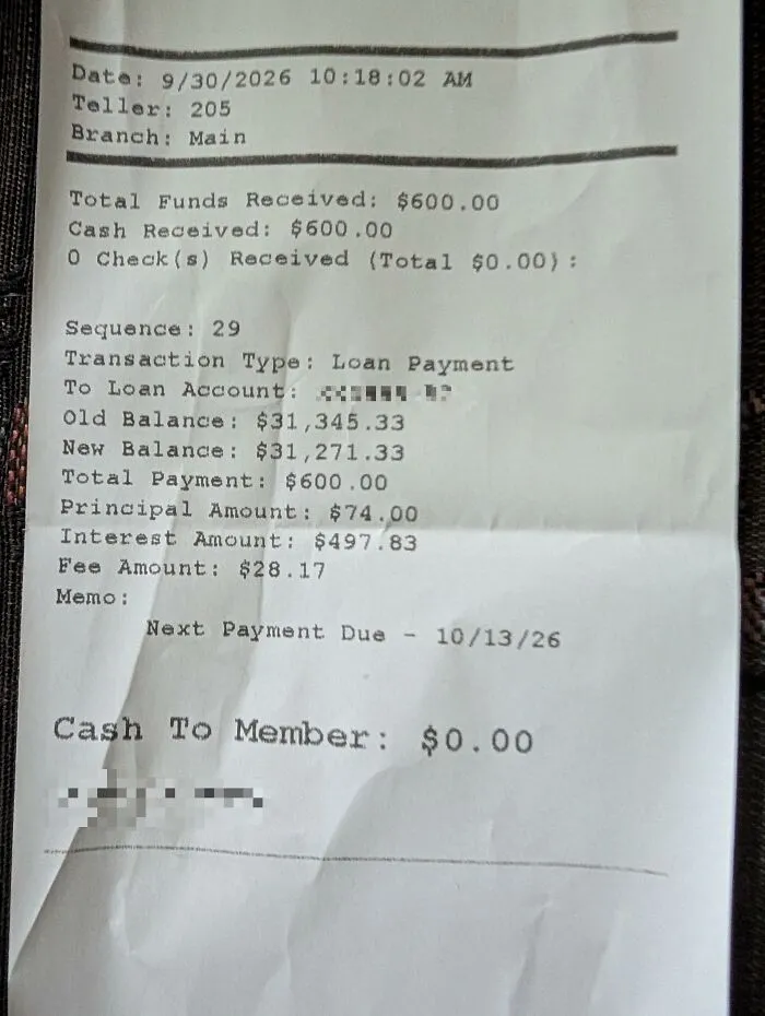 A printed bank receipt showing loan transaction details, serving as a found paper object