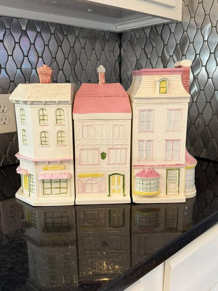 Set of pastel building-shaped canisters, a wonderful thrift find on a kitchen counter.