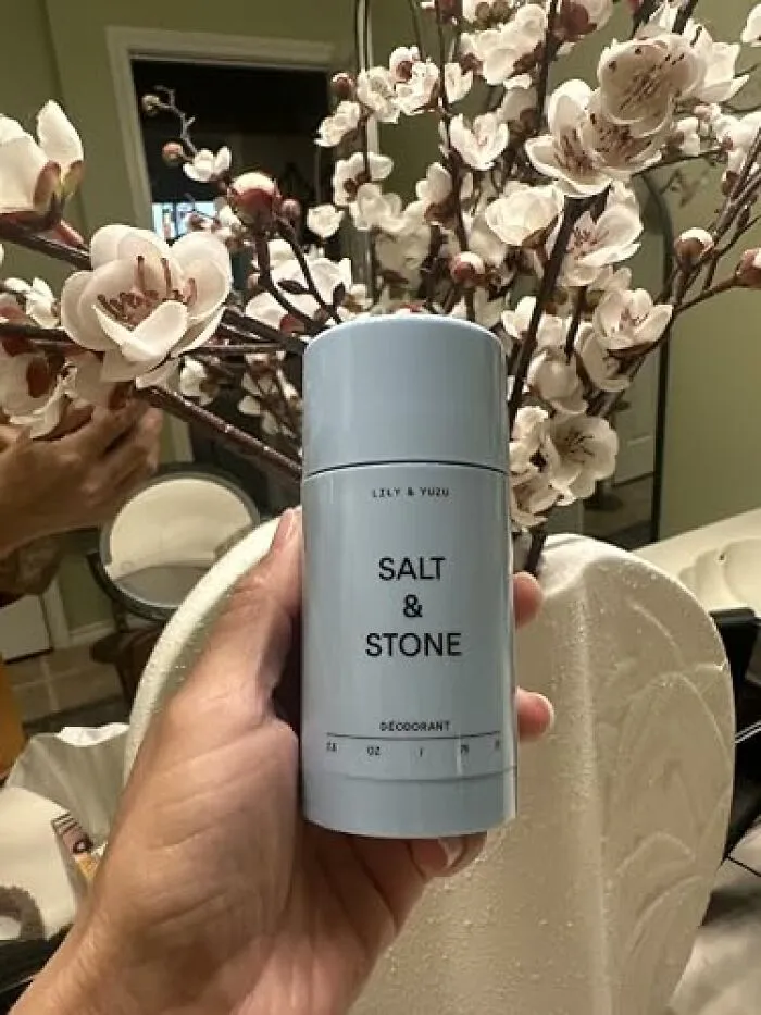 Hand holding a Salt and Stone natural deodorant stick, popular during Amazon Big Deal Days