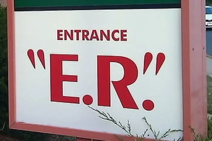 An entrance sign showing misused quotation marks around the letters E.R.