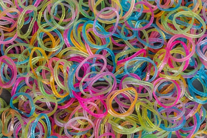 Colorful rubber bands scattered as a symbol of unhinged things to get back at ex