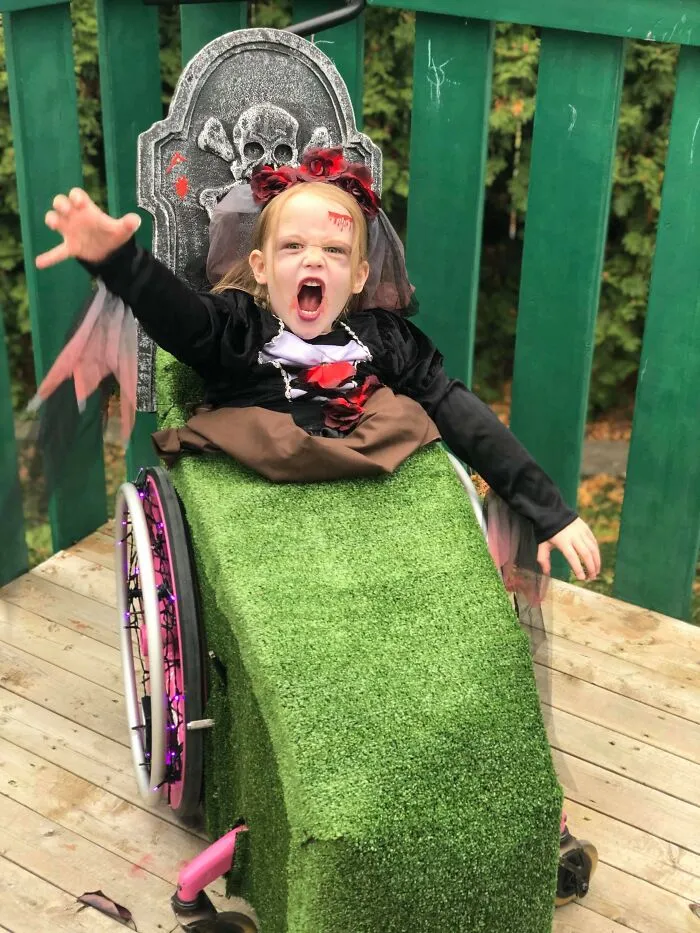 Young girl in a graveyard wheelchair costume, showing how people with disabilities won Halloween.