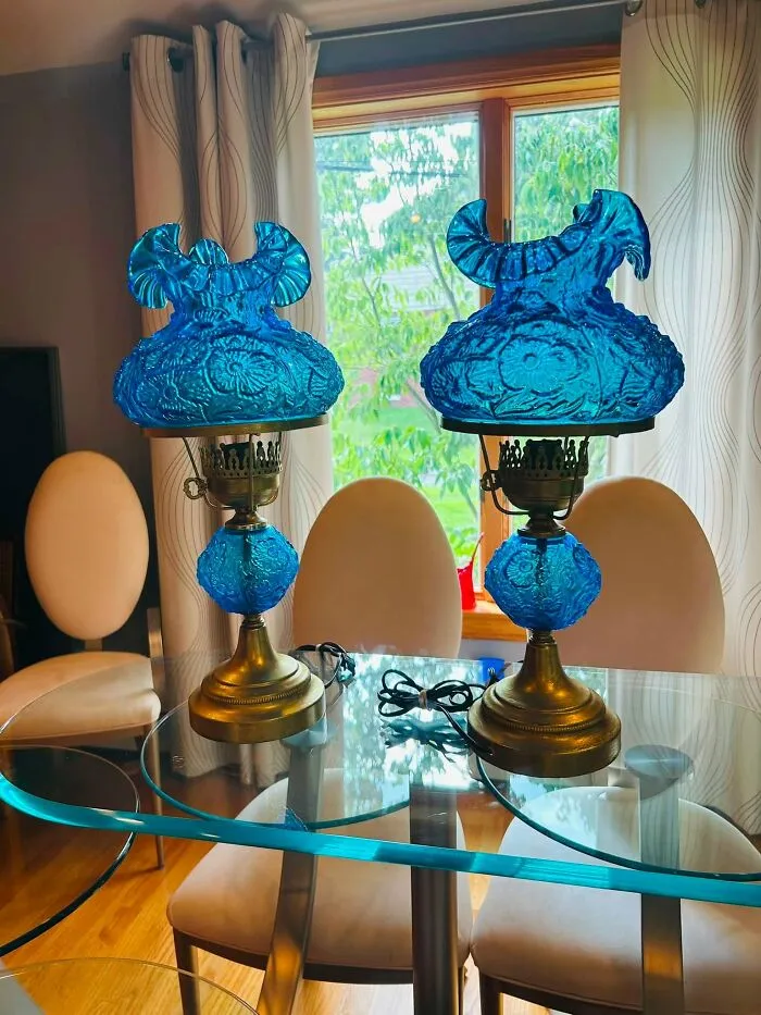 Pair of vintage bright blue glass lamps displayed on a glass table, a unique thrift find