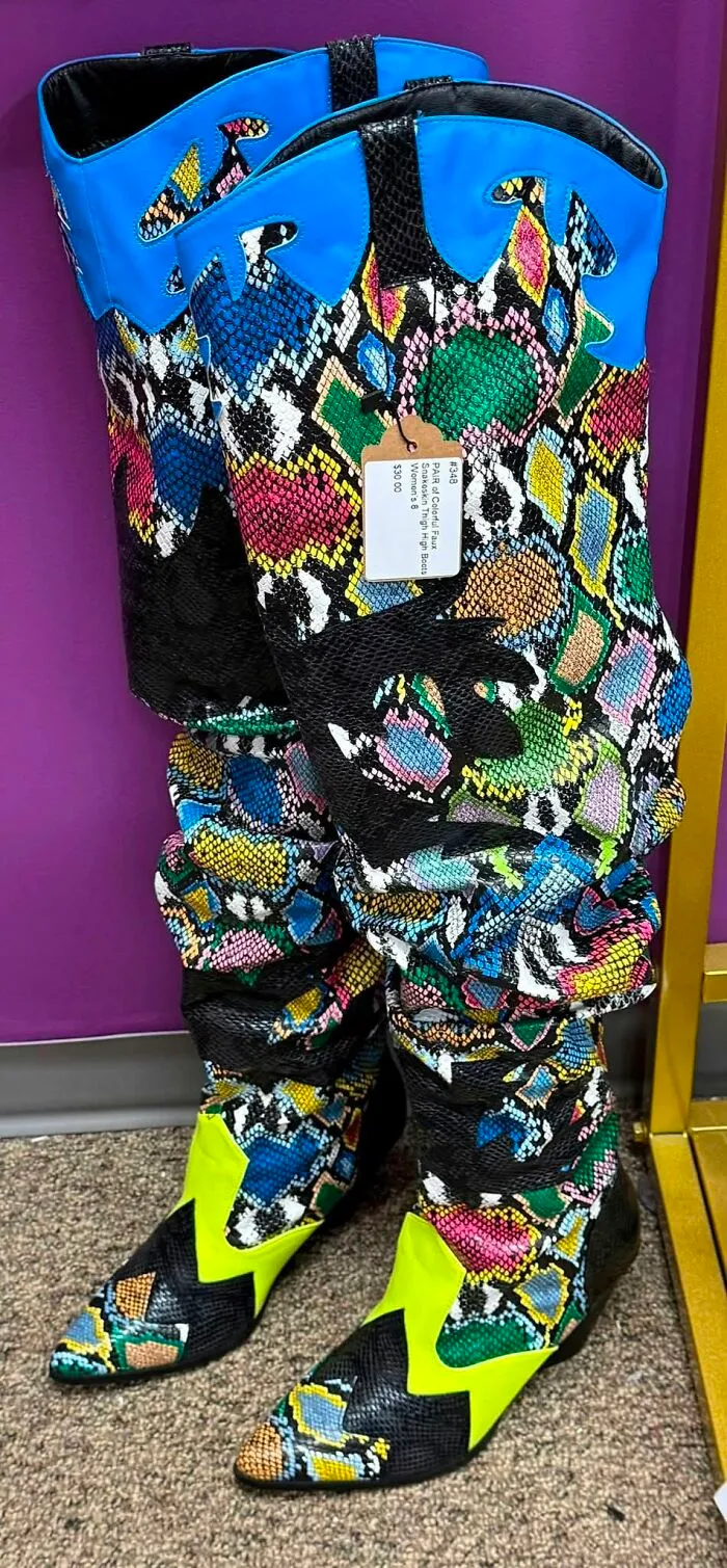 Brightly colored snake print thigh high boots spotted as a unique thrift find at a store.
