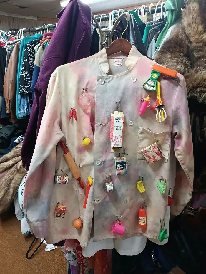 Chef coat adorned with mini plastic kitchen accessories, a strange thrift find