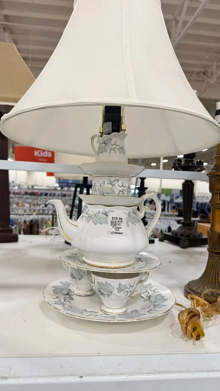 A lamp made out of stacked tea cups and a teapot, an example of unique thrift finds