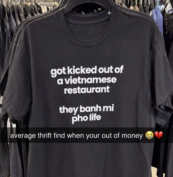 Black T-shirt with funny Vietnamese restaurant pun quote on display