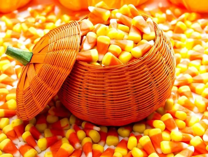 A basket full of classic candy corn sweets representing traditional Halloween Candies.