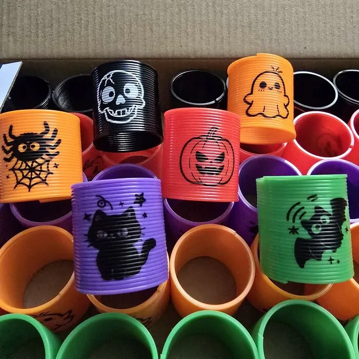 Colorful Halloween themed slinky toys with pumpkin, cat, spider, and ghost designs