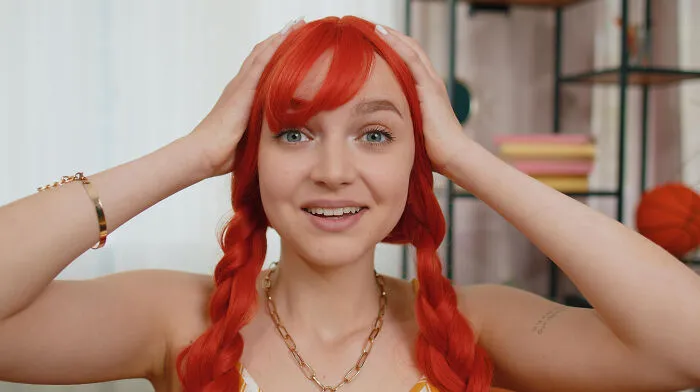 Surprised woman with red hair reacting to obvious lies and truths