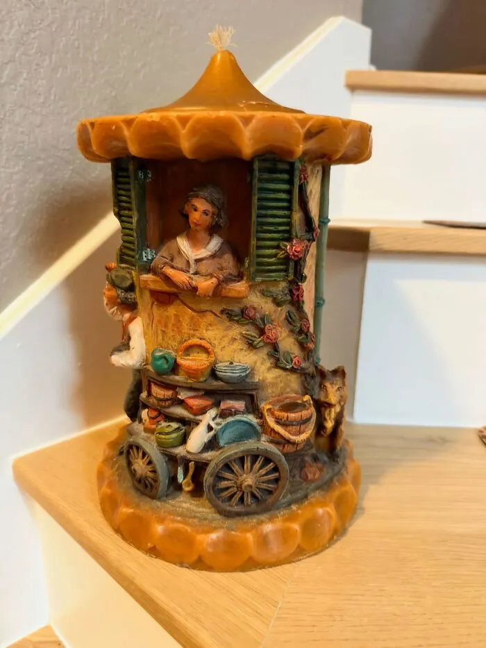 Detailed vintage carved candle depicting a market stall as a thrift store find