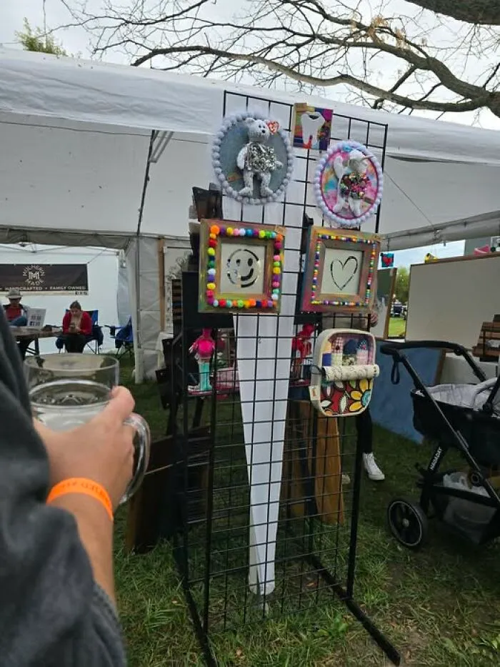 A display of bizarre crafts and art projects at an outdoor market booth