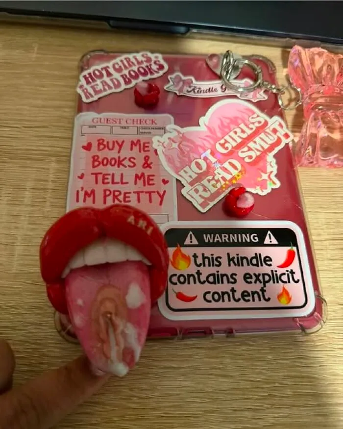 Funny art projects of a decorated pink Kindle case with stickers and an adult themed phone grip