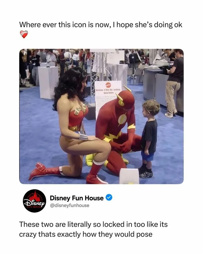 Cosplayers of Flash and Wonder Woman talking to a young child at a pop culture event