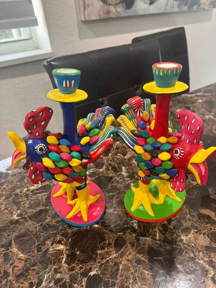 Two colorful hand-painted chicken-shaped candle holders display creative thrift finds