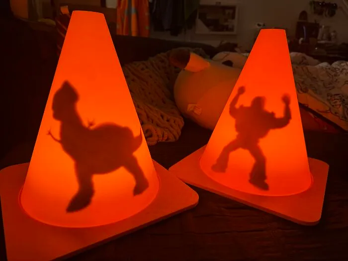 Two orange cones illuminated with Toy Story shadows made via 3D printer