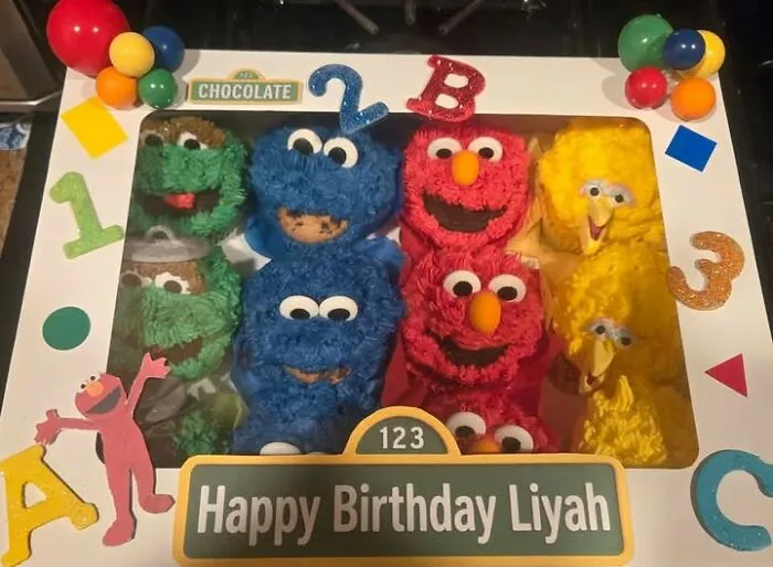 A box of poorly made Sesame Street cupcakes, a hilariously bad art project.