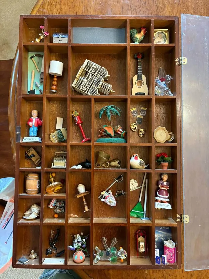 Wooden shadow box filled with miniature collectibles, a weird thrift find.