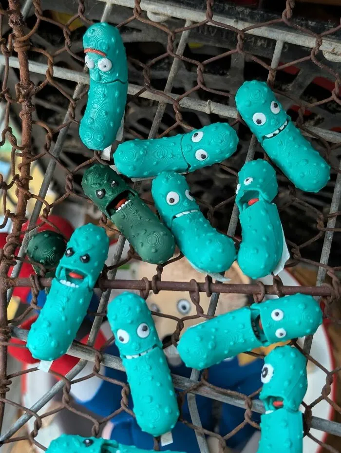 Collection of green pickle character toys featured in thrift finds.