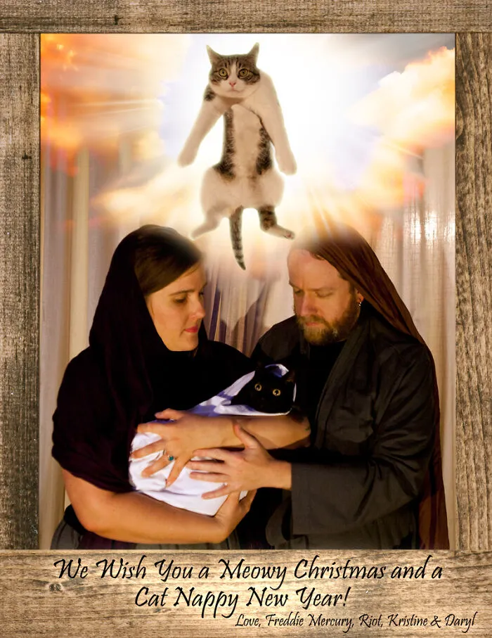 Hilarious family photos with cats showing a couple in nativity costume with a black cat and a flying cat above