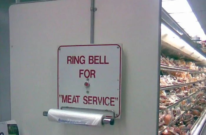 Grocery store bell sign where people misused quotation marks around MEAT SERVICE.