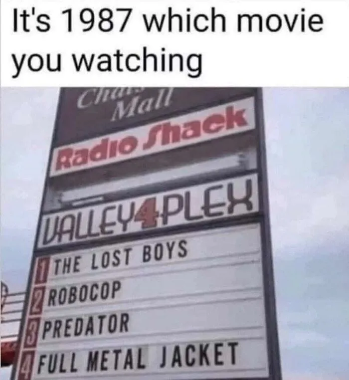 Movie theater sign from 1987 listing 80s classic films, featured in nostalgic photos.