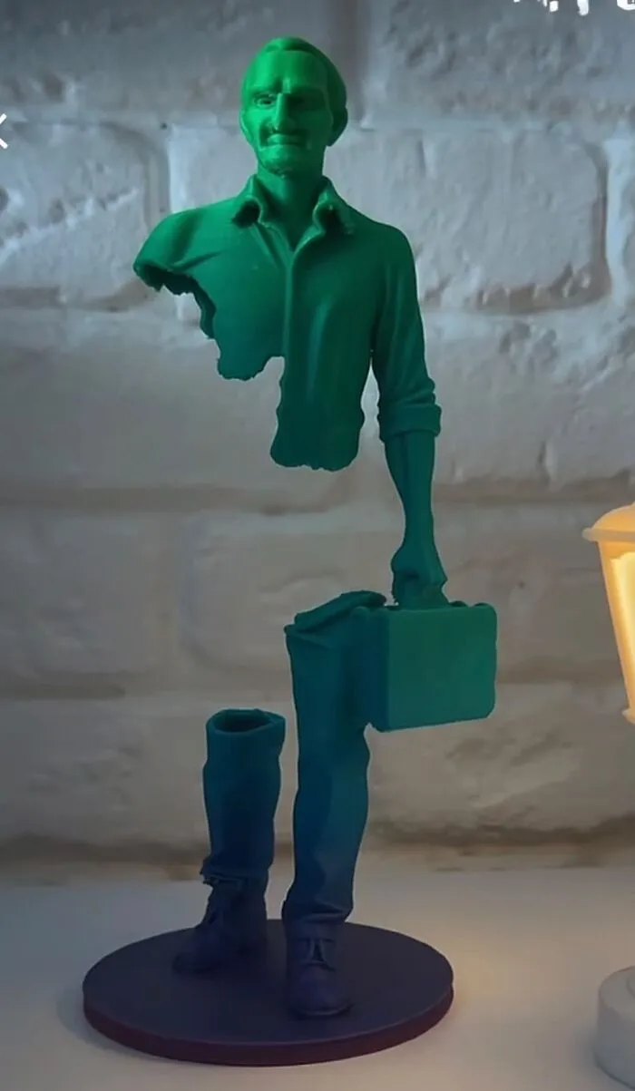 A green surreal sculpture of a floating man as an example of unique 3D prints