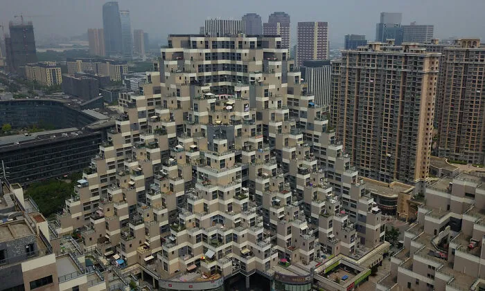Strange stepped pyramid residential building in urban cityscape