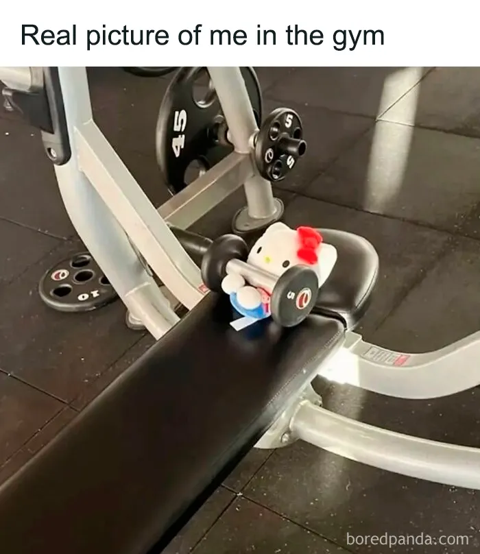 Relatable female gym meme with Hello Kitty toy lifting small weight