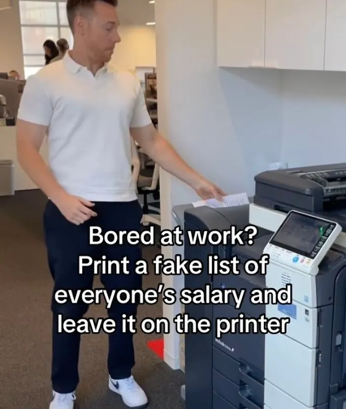 Man printing fake salary list at office printer about financial dystopia life