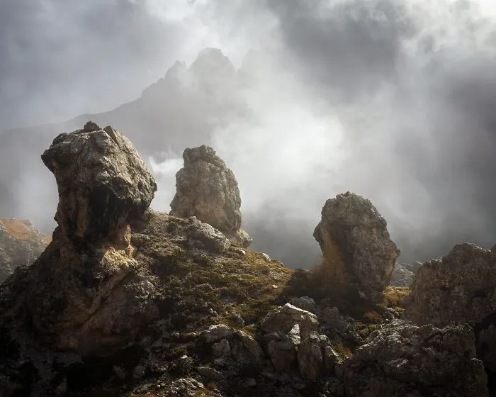 Misty mountain peaks and large rock formations captured in natural landscape photography.