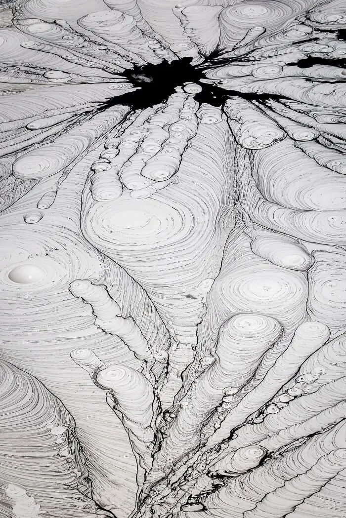 Abstract natural landscape photography of swirling mud pool patterns