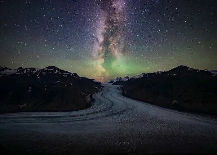 Natural landscape photography awards shot of Milky Way and aurora over a glacier valley