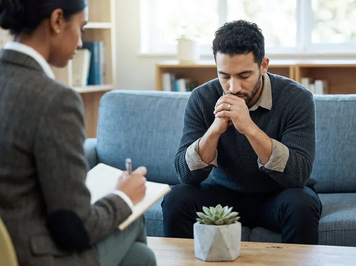 Man in therapy session reflecting on obvious lies