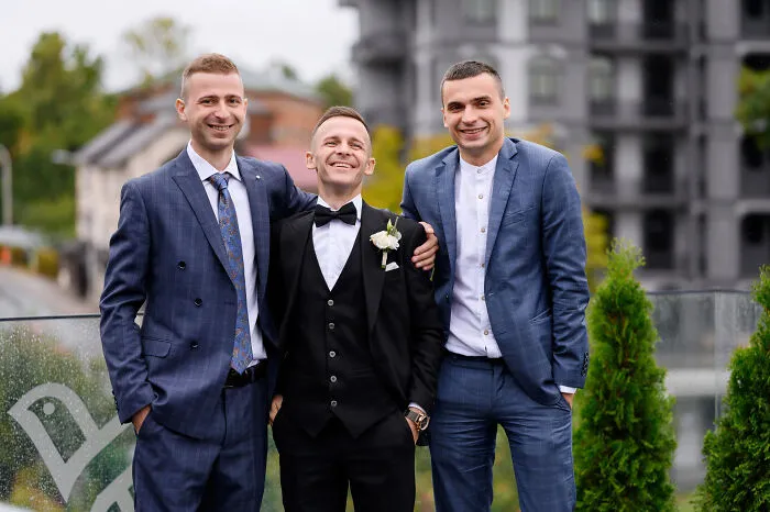 Three happy friends in suits posing together, representing memories before lifelong friendships fizzled out.
