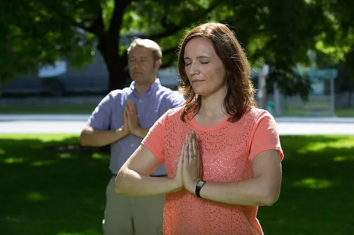A woman and man practicing outdoor meditation, typical of spiritual practices in lesser-known cults.