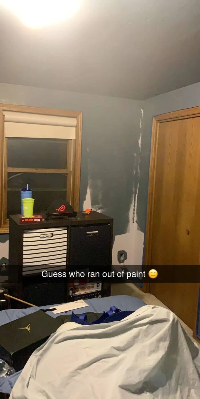 An unfinished blue painted bedroom wall with a Snapchat caption about running out of paint, a home fiasco.