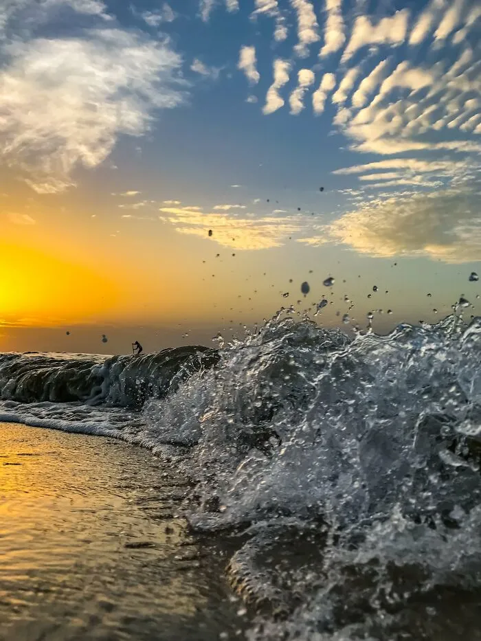 Ocean wave splash at sunset captured with iPhone photography