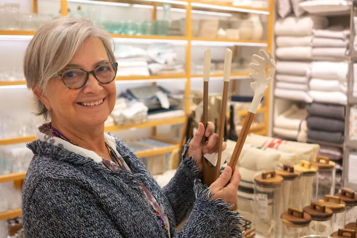 A smiling mother shopping for her kids, illustrating helicopter parenting decision-making.