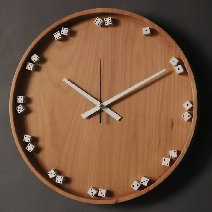A round wooden wall clock using small dice as hour markers.