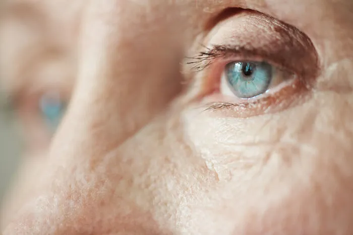 Extreme close-up of a blue eye, representing awareness and emergency tips for vision and head injuries.