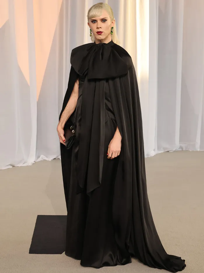 Person wearing black silk cape dress at Academy Museum Gala