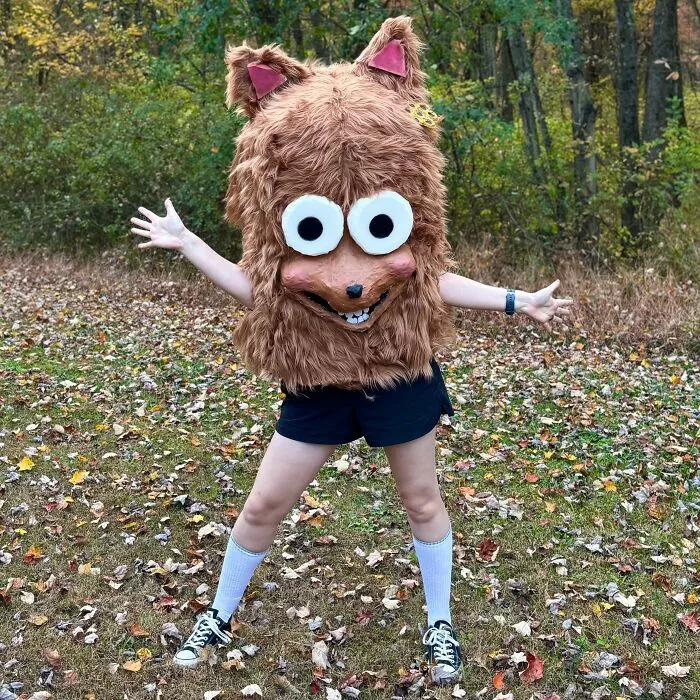 Person wearing furry mascot head as creative Halloween costume idea outdoors