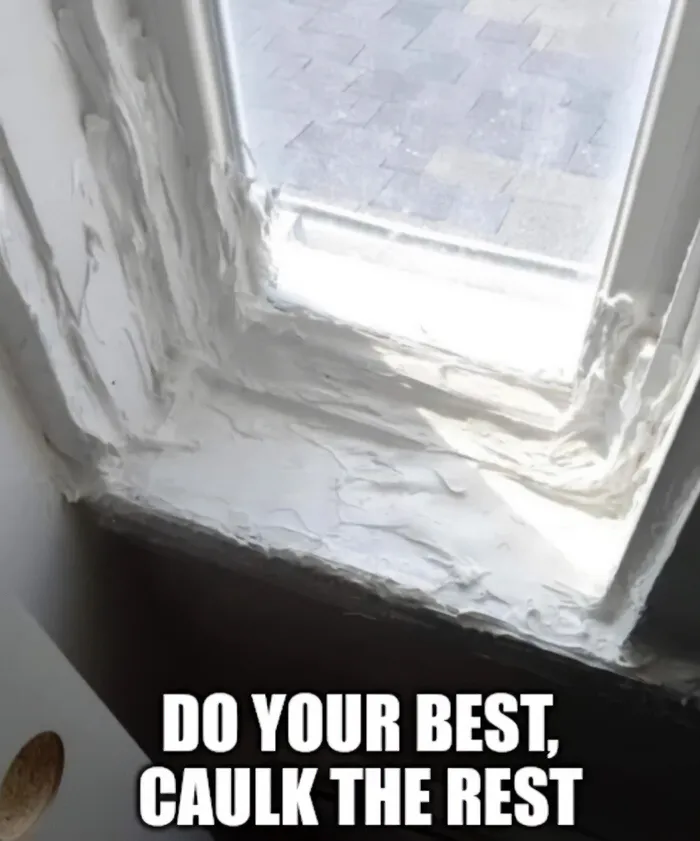 Window frame covered in excessive caulk, illustrating funny cringe construction fails memes.