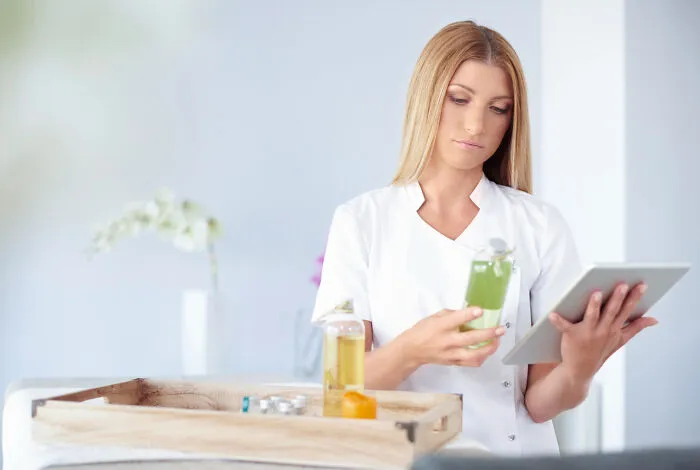 A nurse using a digital tablet to manage medical products and patient records