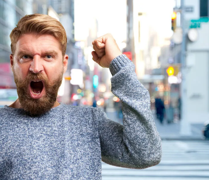 An angry man shouting in the street, representing conflict that makes lifelong friendships fizzle out.