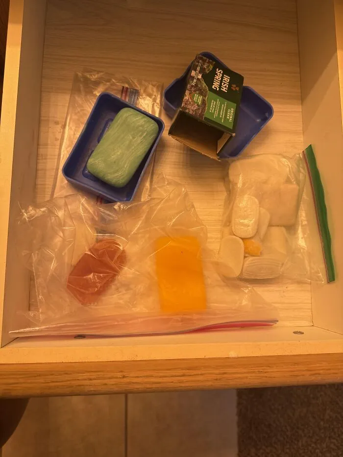 A drawer filled with absurd products like leftover soap bars stored in plastic bags.
