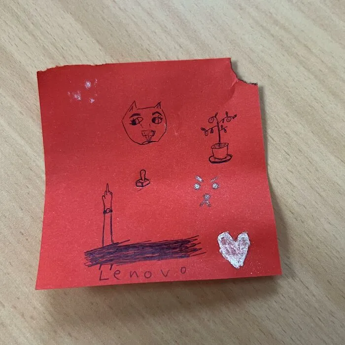Hand-drawn doodles on red paper with Lenovo written on it, representing found paper with lost and forgotten messages.